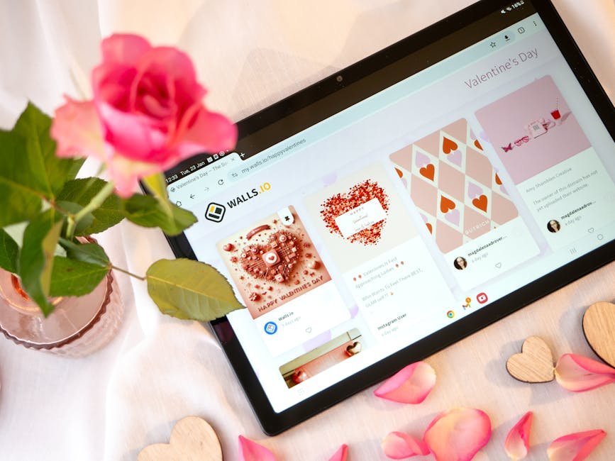 A romantic arrangement with a rose and a tablet displaying Valentine's Day themes. Perfect for romantic or tech-related content.